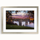 Textured abstract art print of Alabama scenery in muted earth tones, framed in silver, suitable for bedroom decor.