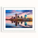 Abstract art print featuring fluid forms in blue and white hues on a framed white mat, ideal for modern dining room decor.