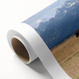 Art deco poster of Grand Tetons landscape on rolled canvas, with muted earth tones, ideal for nursery wall art.