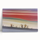 Abstract landscape stretched canvas artwork showcasing vibrant colors and dynamic shapes, perfect for modern home decor. This piece leans against a neutral wall, adding a contemporary touch to any space.