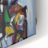 Close-up of vibrant abstract acrylic splatters on glass, showcasing a vivid palette of blues, yellows, and reds, perfect for modern home decor accents.
