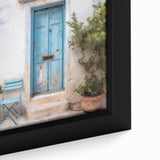 Close-up of a black framed canvas featuring a textured, colorful Greek door design, ideal for living room decor.