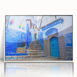 Large art print of a Moroccan landscape in mid-century modernist style, featuring earthy tones on a framed acrylic.