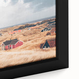Close-up of black textured wall art depicting a colorful European cityscape on a framed canvas.