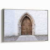 Framed canvas featuring a vintage-style landscape painting of a European scene in muted earth tones.