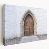 Large art on stretched canvas depicting a scenic European landscape in muted green and blue tones.