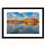 Abstract art print of a colorful, textured European scenery in muted tones, framed in black, ideal for living room decor.