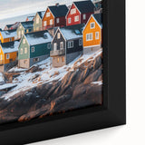 Close-up of black wall art featuring a textured Greenland landscape on framed canvas, with colorful accents.