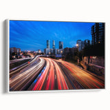Vintage poster art of Madrid scenery on a large framed canvas, featuring colorful artwork against a black background.