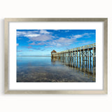 Textured abstract art print depicting an oceanic scene in cool blue tones, framed in silver, ideal for bedroom art.