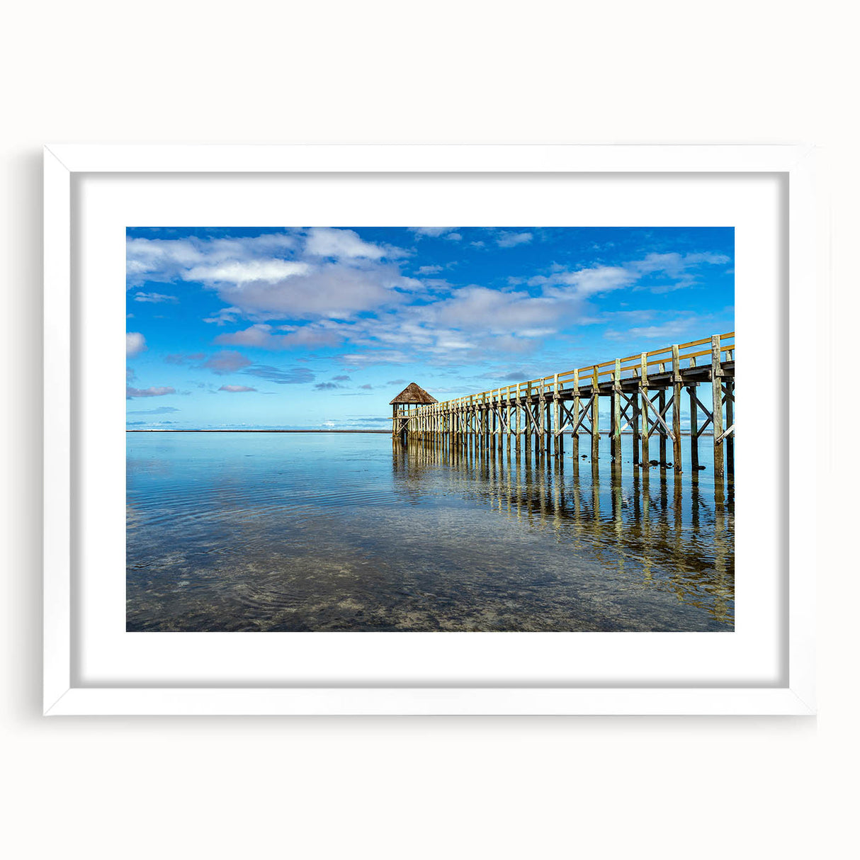 Abstract art print depicting an oceanic scene in blue and green tones on a white framed canvas, ideal for dining room decor.