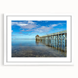 Abstract art print depicting an oceanic scene in blue and green tones on a white framed canvas, ideal for dining room decor.