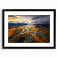 Colorful abstract art print of textured scenery, framed in black, ideal for living room decor.