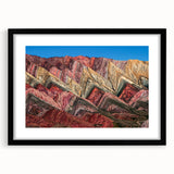 Colorful abstract art print of an Argentine scene, rendered in textured hues, set in a large black frame with mat.