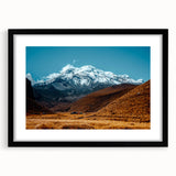 Colorful abstract art print depicting a textured South American scenery in vibrant hues, framed with a black mat.