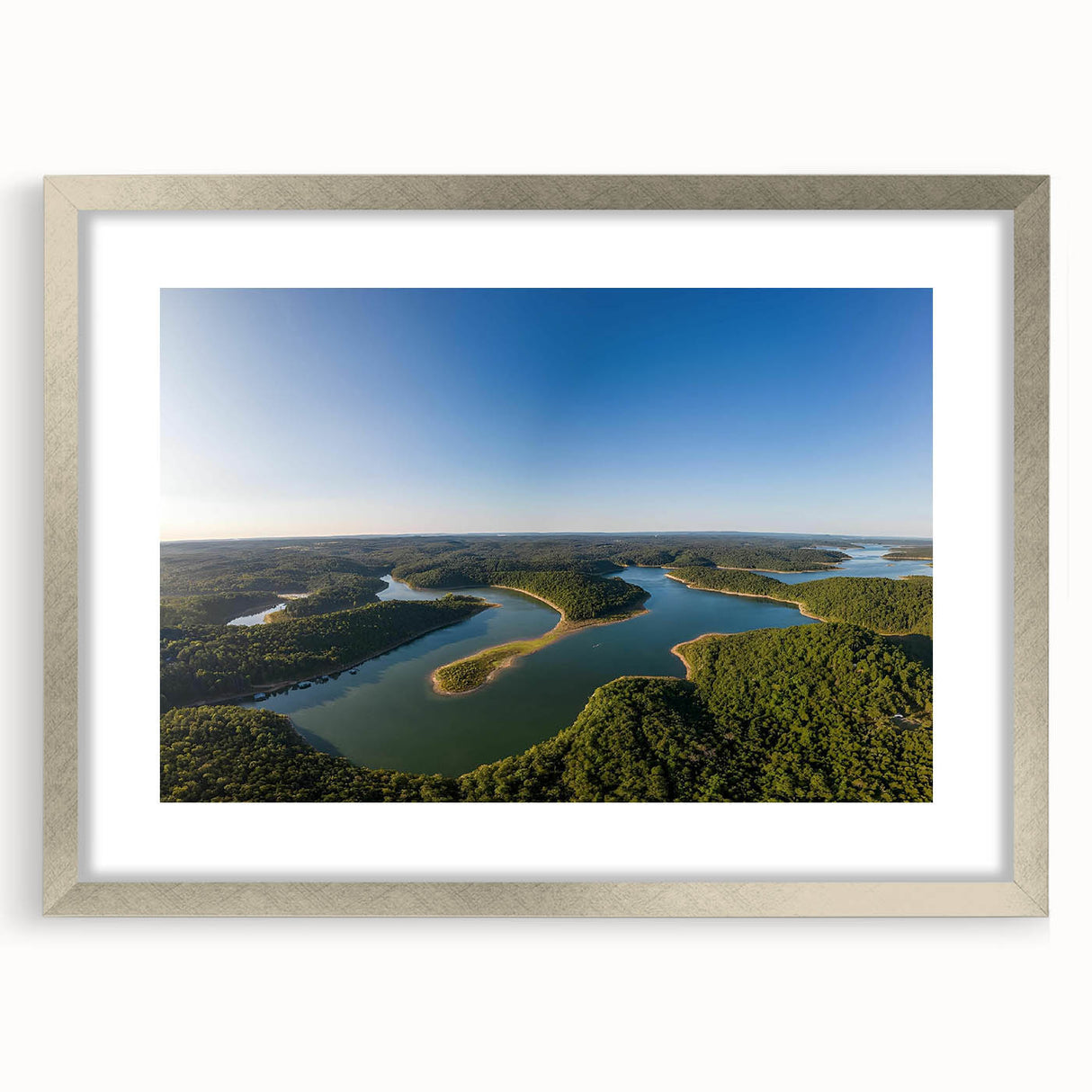 Textured abstract art print of Arkansas scenery in muted earth tones, framed in silver, ideal for bedroom decor.