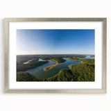 Textured abstract art print of Arkansas scenery in muted earth tones, framed in silver, ideal for bedroom decor.