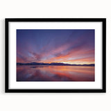 Extra large abstract art print of Lake Tahoe with vibrant colors on textured canvas, framed in black.