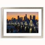 Textured art depicting abstract Los Angeles skyline in muted gray and blue tones on a silver-framed mat.