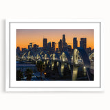 Abstract art print of Los Angeles skyline in muted gray and blue tones on a framed white mat, ideal for dining room decor.
