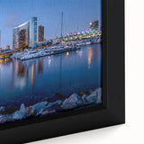 Close-up of textured black wall art featuring a colorful San Diego scenery on a framed canvas.