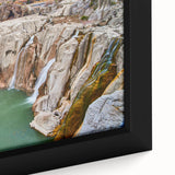 Close-up of a textured Idaho scenery painting on a black framed canvas featuring colorful art.