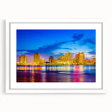 Abstract art print of New Orleans with vibrant blue and gold tones on a white framed canvas, ideal for dining room decor.