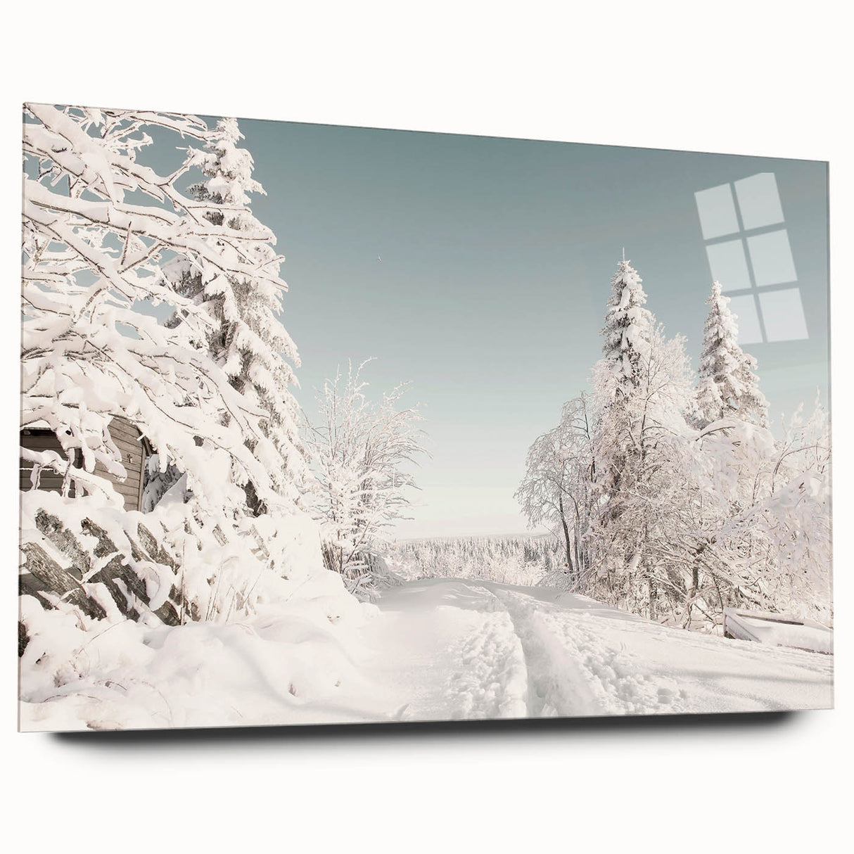 Large abstract wall art of a winter scene in muted blue and white tones on acrylic glass.