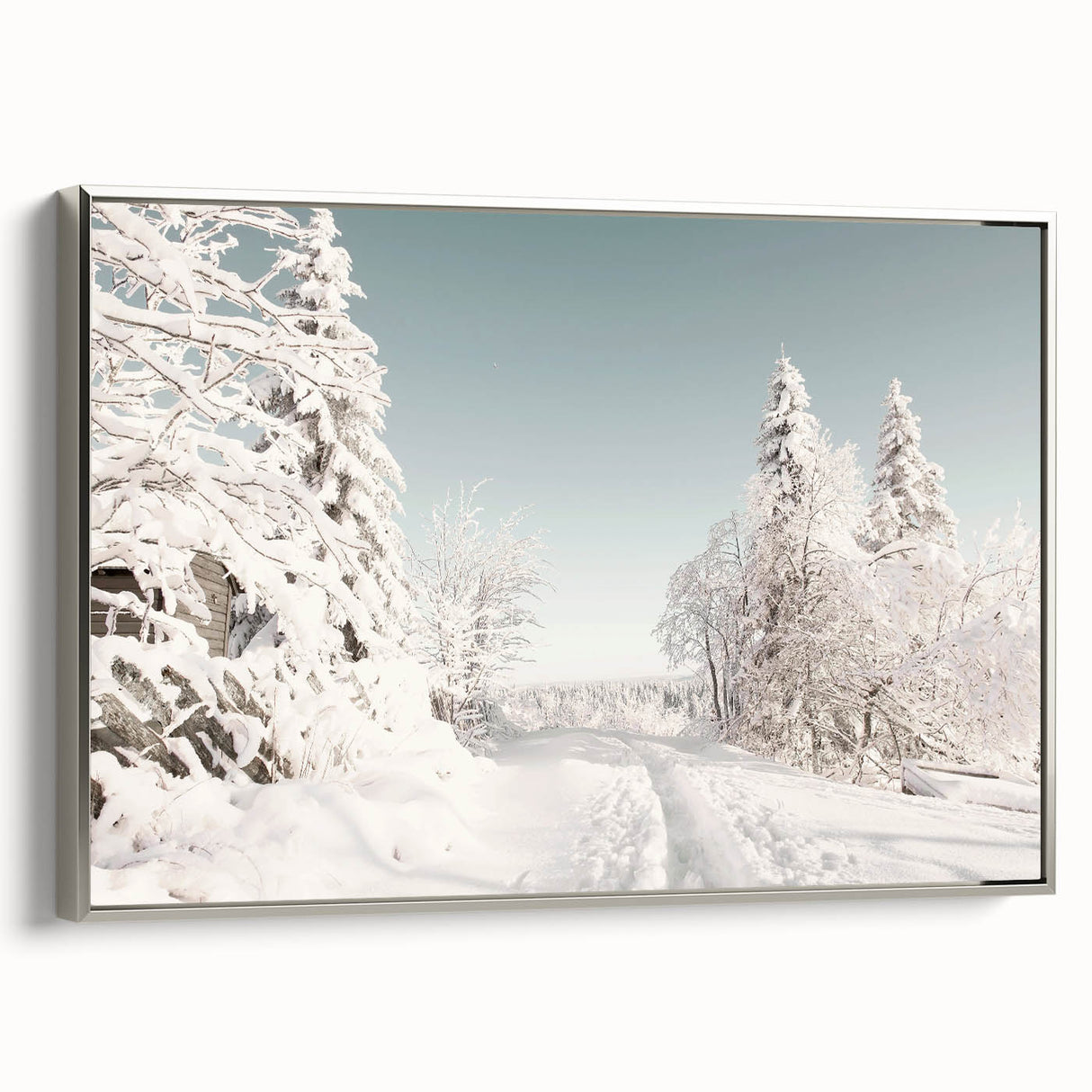 Winter landscape painting on framed canvas, featuring muted blue and white tones, ideal for living room decor.