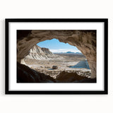 Framed black landscape artwork showcasing intricate cave designs, featuring a modern mat for an elegant finish, ideal for home decor and gallery displays.