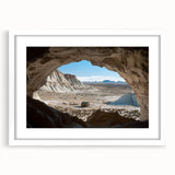 Framed landscape artwork depicting a serene cave scene, featuring natural colors and textures, presented with a white mat for an elegant finish, ideal for home decor.