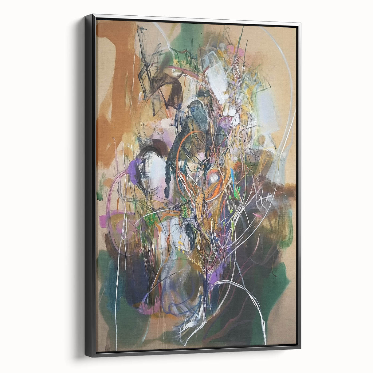Framed canvas artwork showcasing abstract splatter designs in vibrant colors, viewed from the side with a sleek black frame, ideal for modern decor.