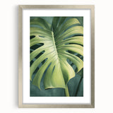 Framed wall art showcasing a floral and botanical design with green leaves on a white background, featuring a sleek silver frame and mat, ideal for home decor.