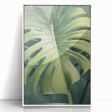 Framed wall art featuring a botanical design with vibrant flowers and green leaves, displayed in a sleek white frame, enhancing modern home decor aesthetics.