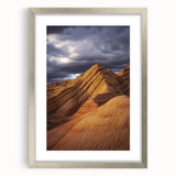 Desert landscape framed artwork in a sleek silver frame with a white mat, showcasing warm tones and intricate details. Ideal for modern home decor.