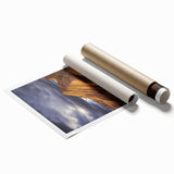 Desert landscape rolled print showcasing vibrant hues of orange and gold, depicting rolling sand dunes under a blue sky, elegantly packaged in a protective tube.