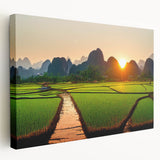 Large art print of an Asian landscape on stretched canvas, featuring green fields and distant mountains.