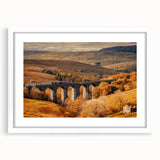 Textured abstract art print depicting a serene Cumbrian landscape in muted earth tones, framed with a white mat.