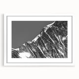 Textured art print depicting abstract French Alps in muted earth tones on a framed white mat, ideal for bedroom decor.