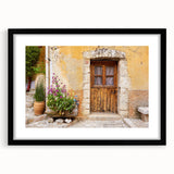 Colorful abstract art print of a Provencal landscape in vibrant hues, framed in black, ideal for living room decor.