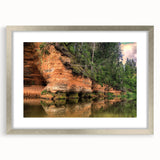 Extra large abstract art print of a textured European landscape in muted earth tones, framed in silver.