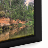 Close-up of extra large framed canvas depicting a black textured European scenery with colorful art accents.