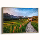 Framed canvas featuring a vintage-style landscape painting of a European scenery in muted gold and black tones.