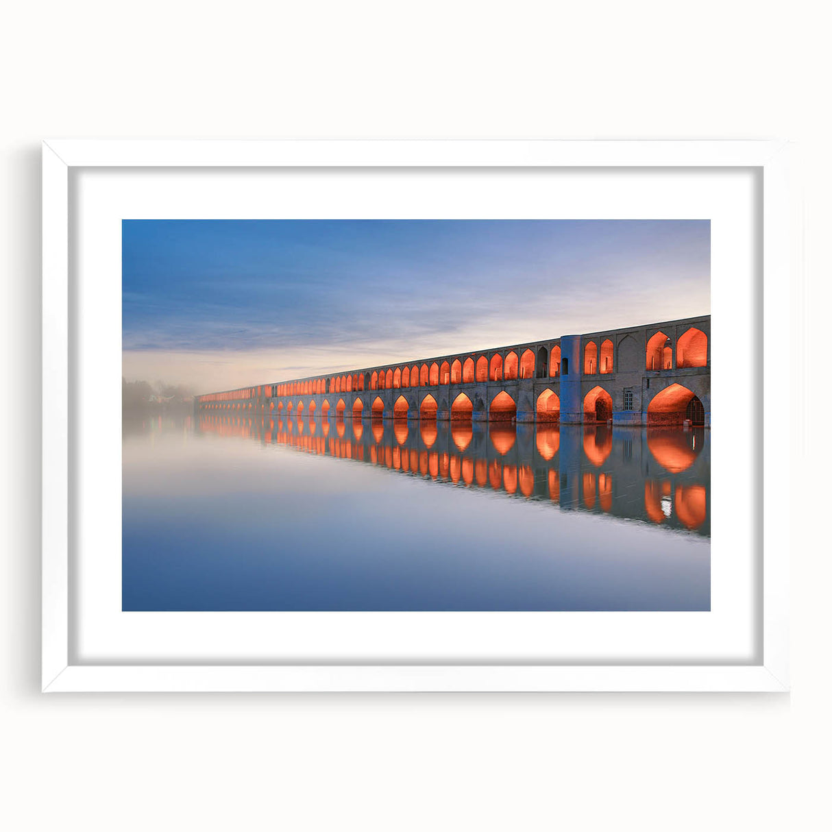 Abstract art print of a Middle Eastern scenery in muted earth tones on a white matted frame, suitable for dining room decor.