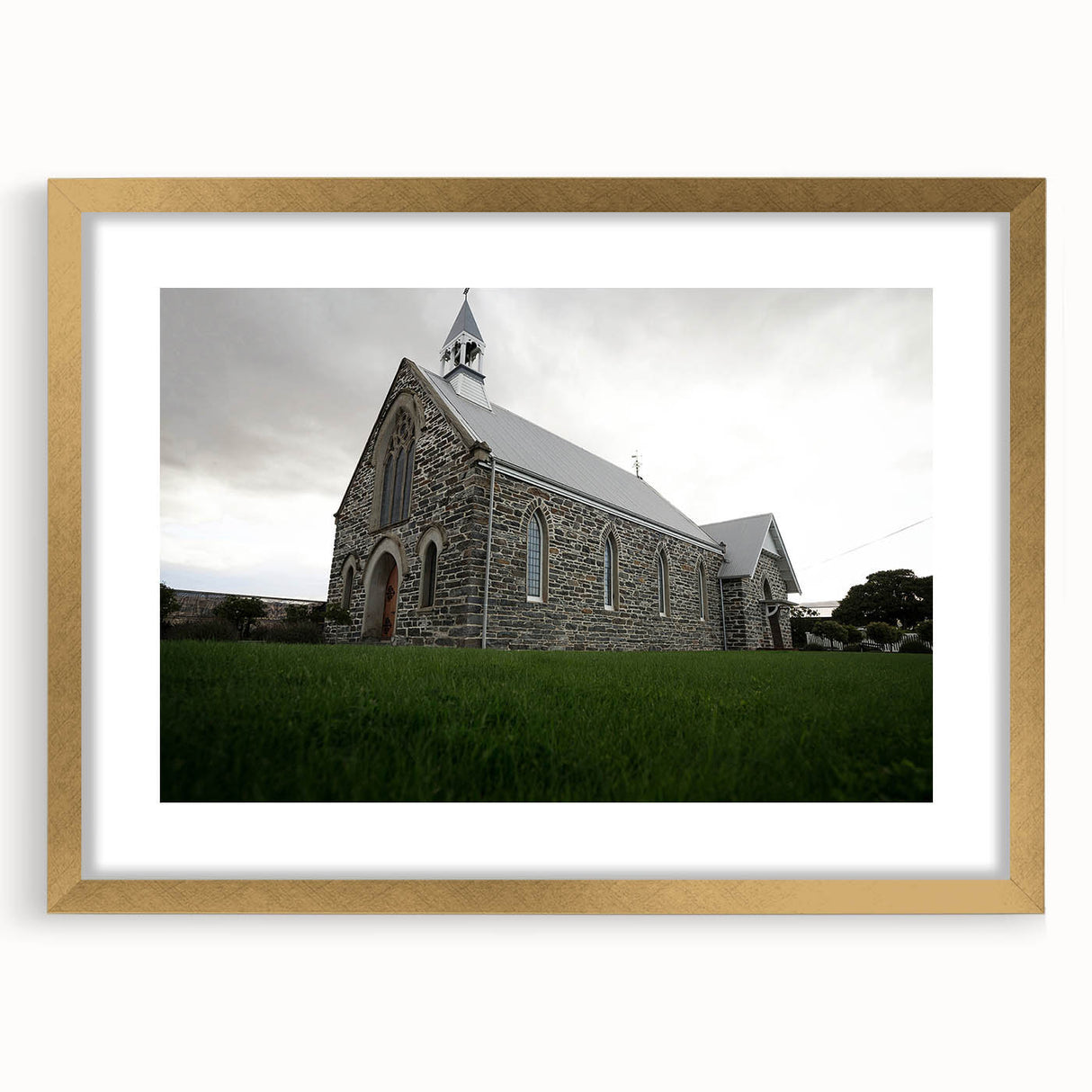 Extra large abstract art print of Otago, New Zealand scenery in gold frame, featuring textured blue and green tones.