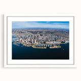 Abstract art print of San Diego skyline in muted blue and gray tones, framed with a white mat, ideal for dining room decor.