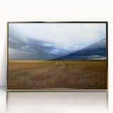 Large art print of a Kansas scenery in muted earth tones on acrylic, framed in gold, suitable for modern nursery wall decor.