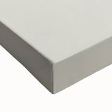 Close-up of a large art piece featuring a black and white landscape with fruits on stretched canvas.