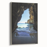 Framed canvas artwork depicting a serene landscape with intricate cave formations, featuring a sleek silver frame, ideal for modern home decor.