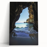 Stretched canvas artwork showcasing a vibrant landscape with intricate cave formations, leaning against a textured wall, ideal for home decor enthusiasts.